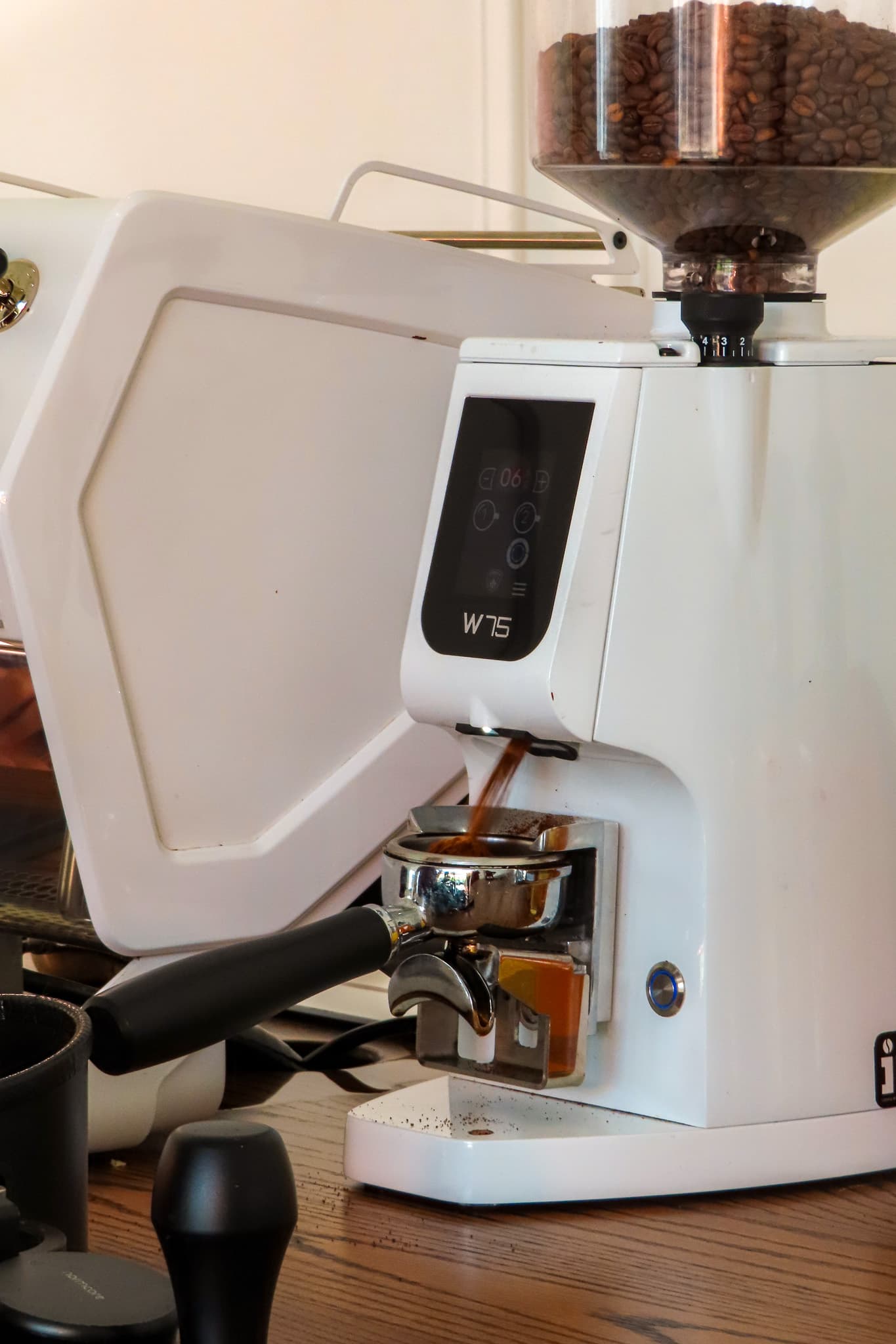 The Hilal Coffee espresso grinder dosing a portafilter in Allen, Texas